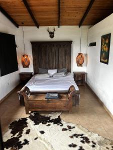 a bedroom with a large wooden bed in a room at La Gloria Ranch 