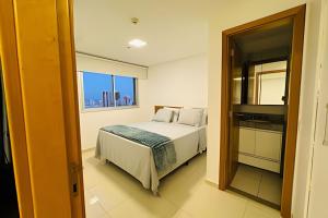 a bedroom with a bed and a window at Apt Luxo VI no Shopping Df Plaza in Brasilia +50 photos