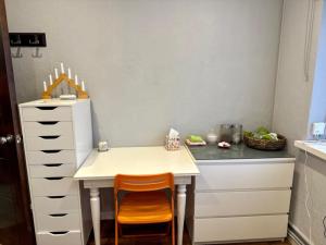 a small kitchen with a table and two chairs at Hathaway guest room in Greenford