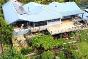 an aerial view of a house with a blue roof at Misty River in Macksville