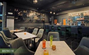a restaurant with tables and chairs and a bar at Acacia Hotel Bacolod in Bacolod +7 photos