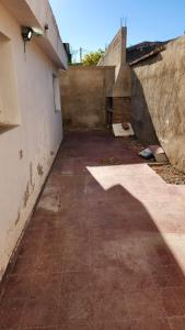 an empty alley with a shadow of a building at Casa Famatina in Chilecito