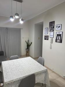 a dining room with a white table and chairs at DPTO BOULEVARD GALVEZ CON COCHERA, Santa Fe in Santa Fe +1 photo