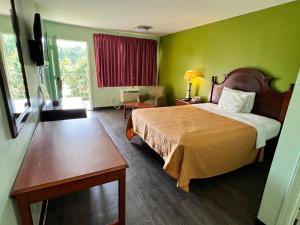 a hotel room with a bed and a window at Travelers inn in Bethania Station