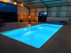 a large swimming pool in a large building at La roulotte MAGIC ! des Grillots in Beaulon +14 photos