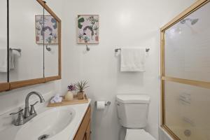 a bathroom with a toilet and a sink and a shower at Dazzling 4BR Near Amazon Studios Venice Beach in Los Angeles +26 photos