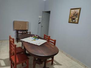 a dining room with a wooden table and chairs at Casa del Arbol in San Fernando del Valle de Catamarca