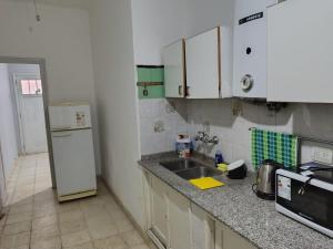 a kitchen with a sink and a refrigerator at Casa del Arbol in San Fernando del Valle de Catamarca