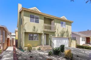 a large green house with a garage at Dazzling 4BR Near Amazon Studios Venice Beach in Los Angeles