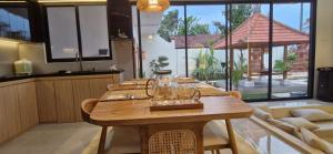 a wooden table with glasses on it in a kitchen at 1 Bedroom Private Villa with Kitchen in Mendaya