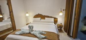 a bedroom with a bed with a towel on it at 1 Bedroom Private Villa with Kitchen in Mendaya