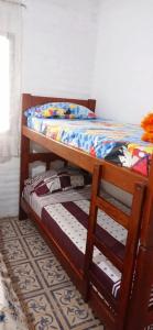 two bunk beds in a room with a bed at La bonita II in San Pedro de Colalao