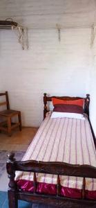 a bed in a room with a wooden frame at La bonita II in San Pedro de Colalao