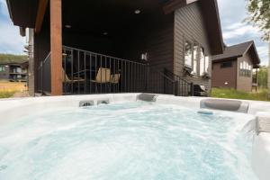 a hot tub in the backyard of a house at Silly Goose Lodge in Granby
