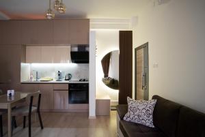 a living room and kitchen with a couch and a table at Gratia Apartments in Kumanovo