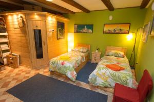two beds in a room with green walls at Rozina Vacation House in Pliskovica