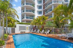 a swimming pool in front of a building at Mirage 801 in Tuncurry