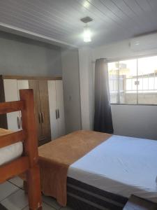 Ένα ή περισσότερα κρεβάτια σε δωμάτιο στο Hospedagem Casa Tomasi