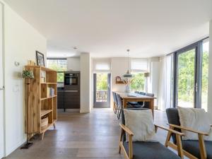 a kitchen and living room with a table and chairs at Holiday home Waterland for six Person in Egmond aan den Hoef