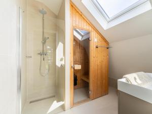 a bathroom with a shower and a glass door at Holiday home Waterland for six Person in Egmond aan den Hoef +27 photos