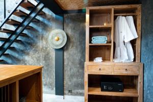a room with a wooden cabinet with a staircase at Lorel Green Domain Ubud in Ubud +65 photos