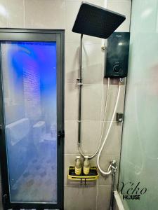 a bathroom with a shower with a light on the wall at Nhà có sân thượng cây xanh view đẹp không gian yên tĩnh in Xóm Bình Nguyên