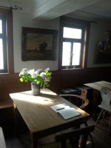 um quarto com uma mesa de madeira com flores em Roter Löwe em Heiligkreuzsteinach