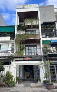 an apartment building with plants on the balconies at Emirlan Homestay in Hue