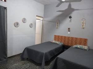 a room with two beds in a room with a ceiling at hostal Rokah on line in Lázaro Cárdenas