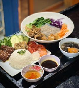 a tray with different types of food on a table at Cô Ba Homestay Măng Đen in Kon Von Kla