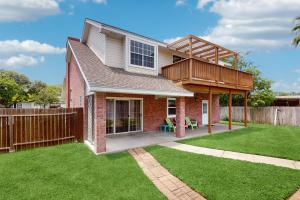 a house with a green lawn in front of it at Pelican Pete in Corpus Christi