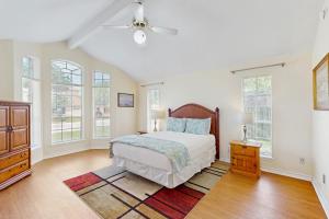 a bedroom with a bed and a ceiling fan at Pelican Pete in Corpus Christi