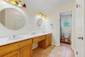 a bathroom with a sink and a toilet at Pelican Pete in Corpus Christi +17 photos
