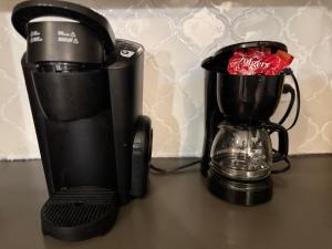 a coffeemaker and a coffee maker on a table at Le Belle - 4 Bdrm with Pool Table - Pet Friendly in New Orleans +1 photo
