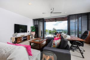 a living room with a couch and a table at The heights Kata seaview C1 near Kata Beach in Kata Beach