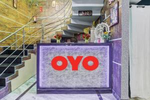 a store sign in a hallway with stairs at Super Hotel O Kiara Villa Matiyari Chauraha Chinhat Bus Stop in Chinhat