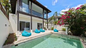 an exterior view of a house with a swimming pool at Aqua Vista 02 - 4BR Villa Near the Beach in Amphoe Koh Samui