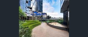 a walkway in front of a tall building at 2-Bedroom Apartment in Melbourne CBD with Balcony, Pool & Gym Access in Melbourne