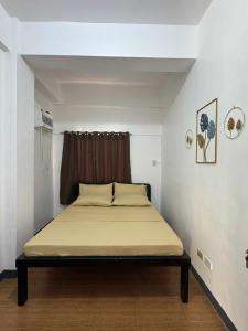 a bedroom with a bed in a room with a window at GLC Tourist Inn in Coron +11 photos