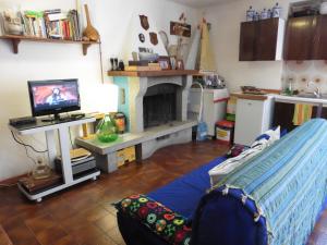 a living room with a tv and a fireplace at Casa Vacanza San Piero in San Piero in Campo +3 photos