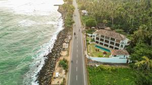 an aerial view of a road next to the ocean at Marshmallow Bay Boutique Hotel & Surf Point Adults Only in Ahangama
