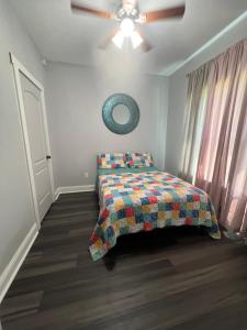 a bedroom with a bed and a ceiling fan at Morning Glory in Longview +2 photos