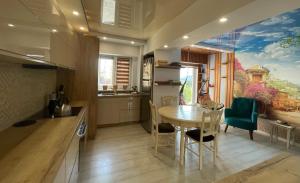 a kitchen with a table and a dining room at Happy Time 1 in Petroşani