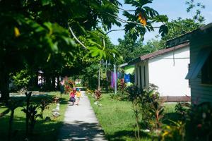 two children walking down a sidewalk in a yard at Naqeresa in Tethi +4 photos
