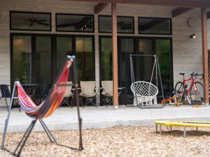 a group of chairs and bikes in front of a building at TrollForestStella in Nikko