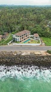 an aerial view of a house next to the ocean at Marshmallow Bay Boutique Hotel & Surf Point Adults Only in Ahangama