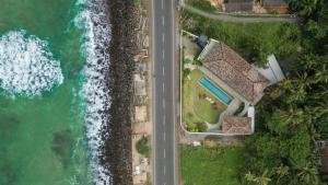 an aerial view of a house next to the ocean at Marshmallow Bay Boutique Hotel & Surf Point Adults Only in Ahangama