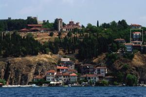 a group of houses on a hill next to the water at Maslov Apartments in Ohrid