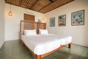 a bedroom with a large white bed in a room at Marshmallow Bay Boutique Hotel & Surf Point Adults Only in Ahangama