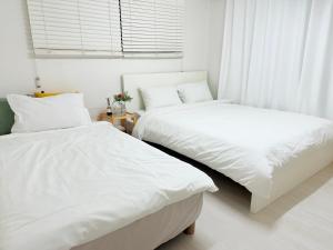 En eller flere senge i et værelse på Gangnam Nonhyun comfortable lodging